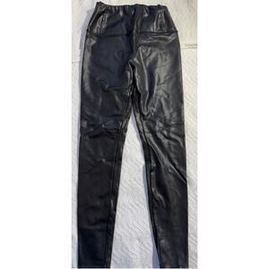 black faux leather leggings by La Classe Couture.